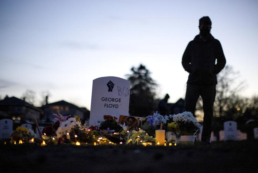 A person stands at the "Say Their Names" cemetery on the day of the guilty verdict in the trial of former Minneapolis police officer Derek Chauvin, at George Floyd Square in Minneapolis, Minnesota, on April 20, 2021.